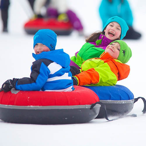 picture of young kids riding in snow tubes at Loon Mountain Resort, NH